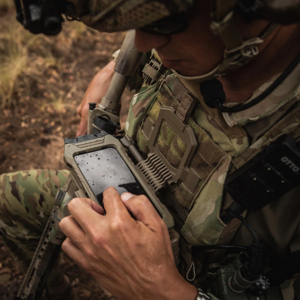 Operator working a chest-mounted rugged tablet in the field
